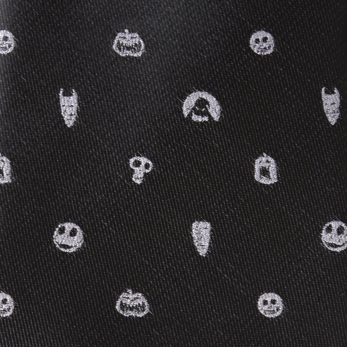 Black fabric with white embroidered Halloween-themed patterns including pumpkins, ghosts, and ghosts. Nightmare Before Christmas