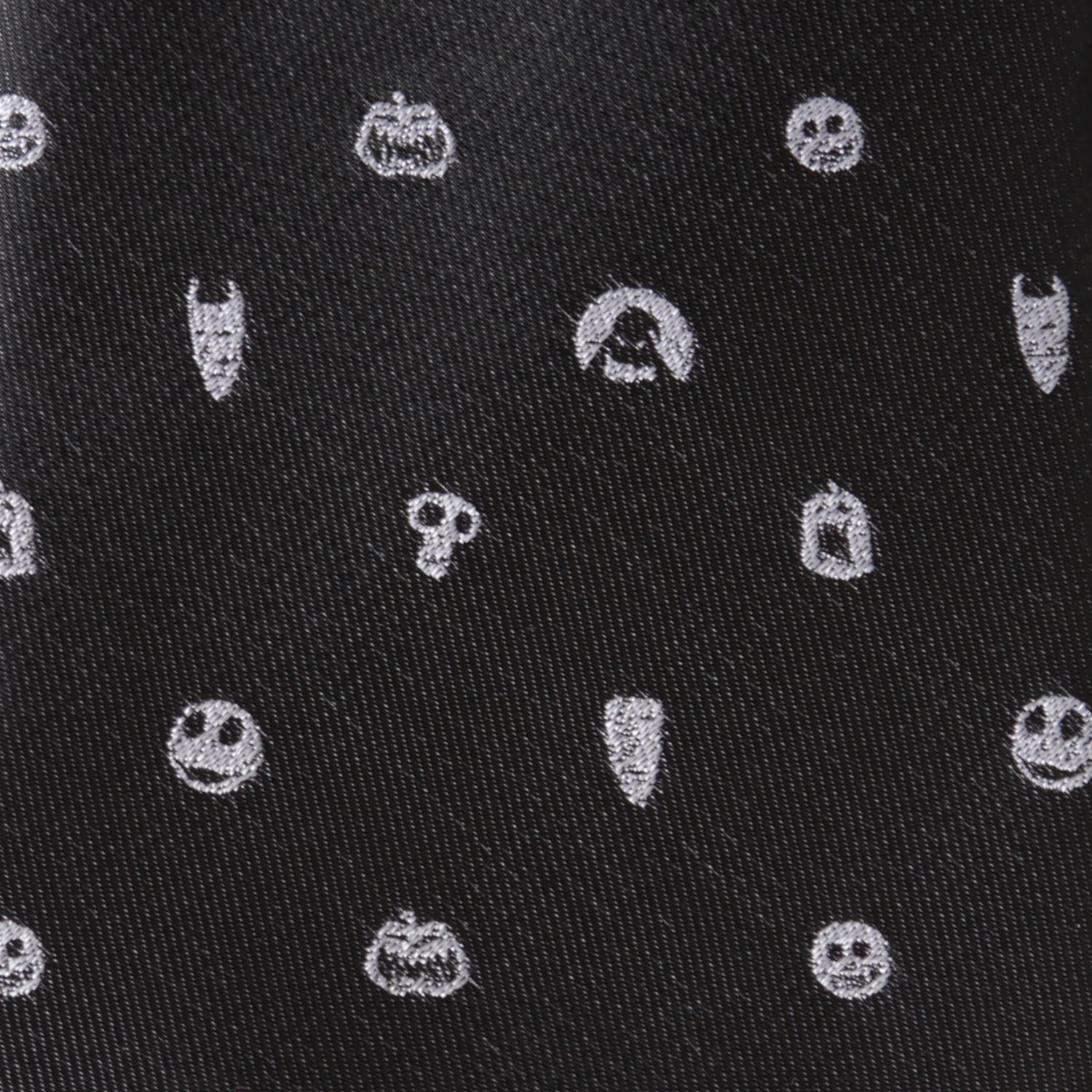 Black fabric with white embroidered Halloween-themed patterns including pumpkins, ghosts, and ghosts. Nightmare Before Christmas