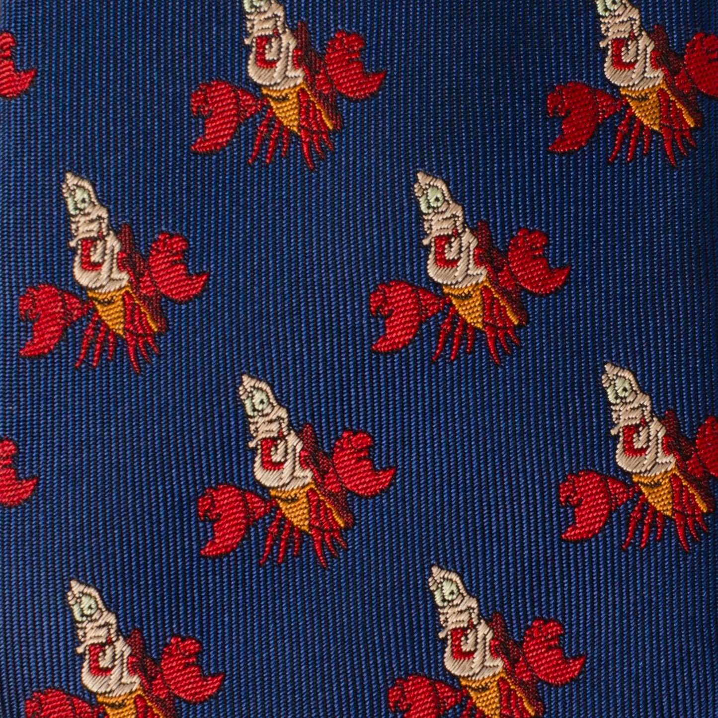 Patterned fabric with red and white lobster design on a blue background Little Mermaid Sebastian