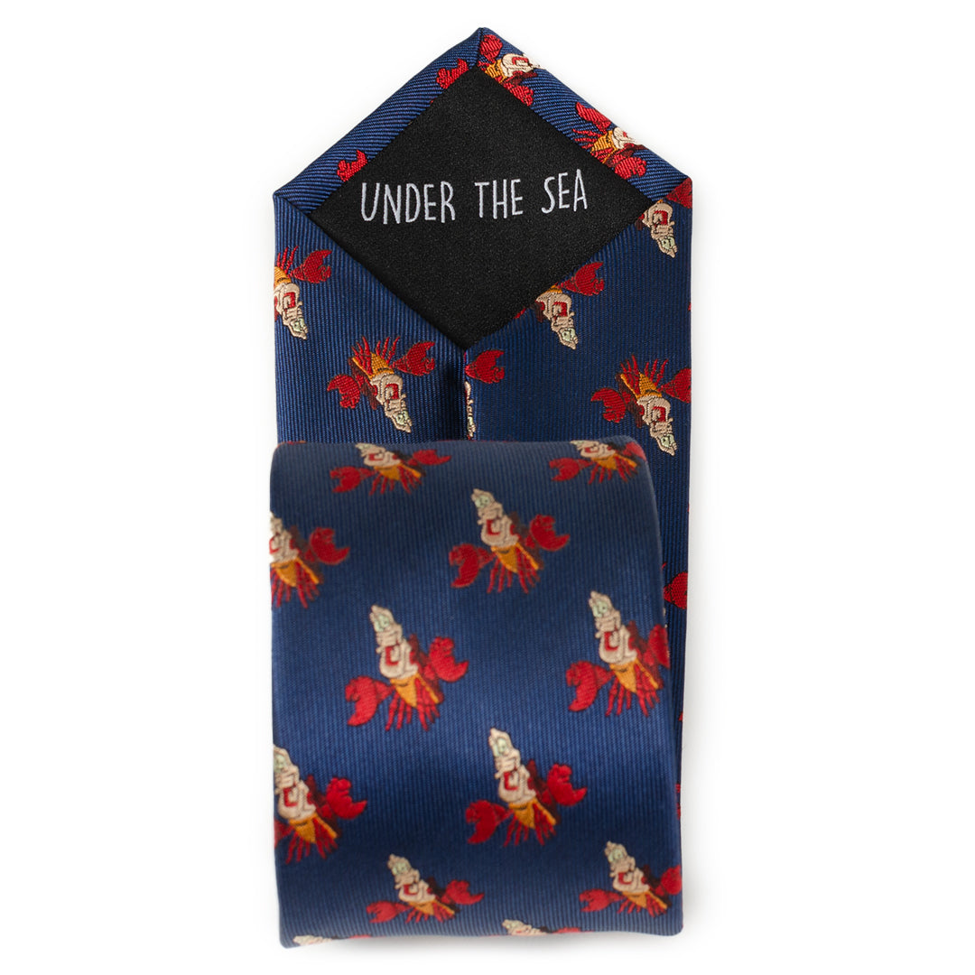 Navy blue tie with mermaid pattern and matching pocket square on a white background