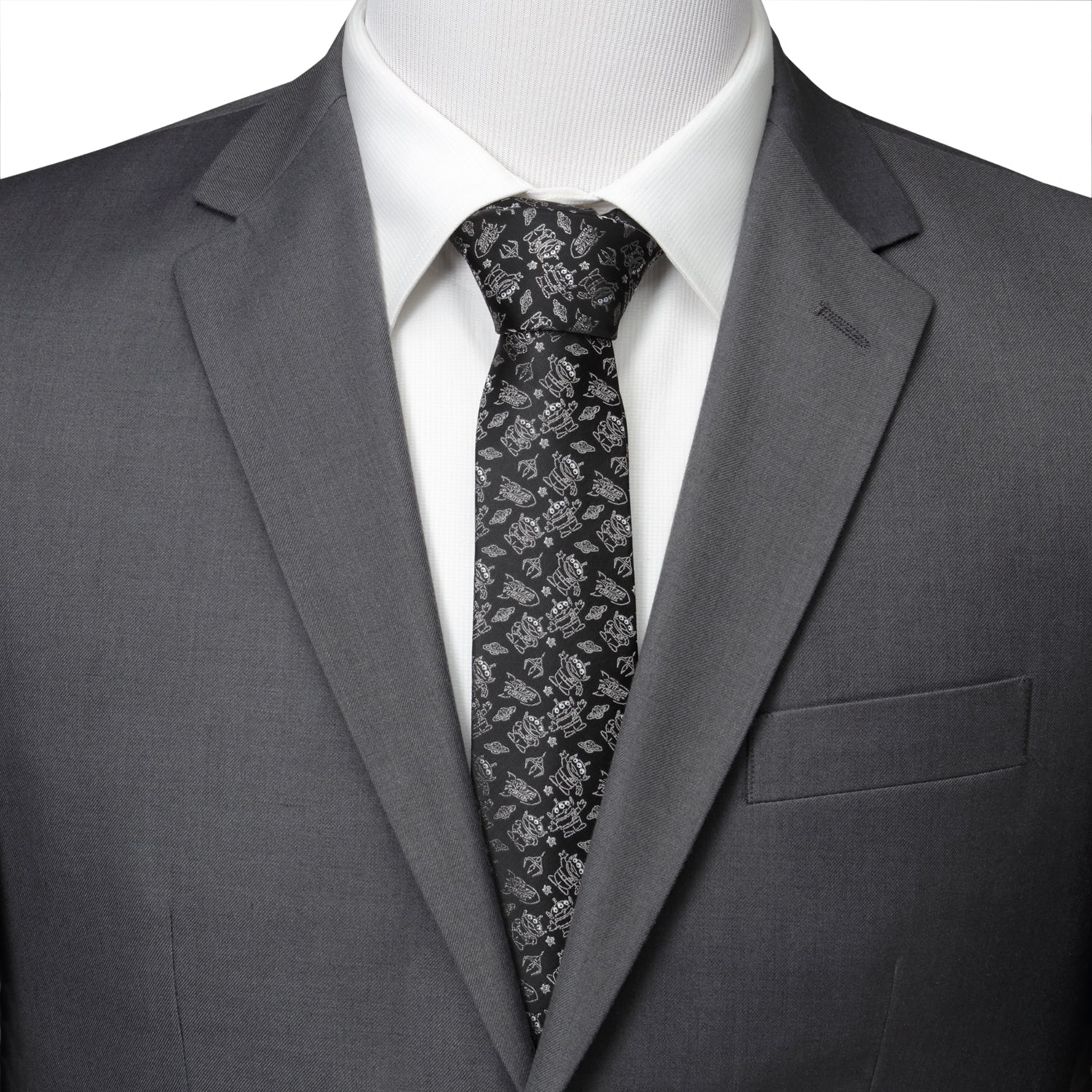 Gray suit with a white shirt and patterned tie on a mannequin.
