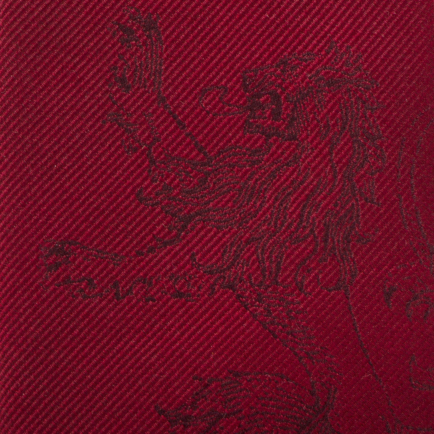 Close-up of a red fabric with a black embroidered design on a red background