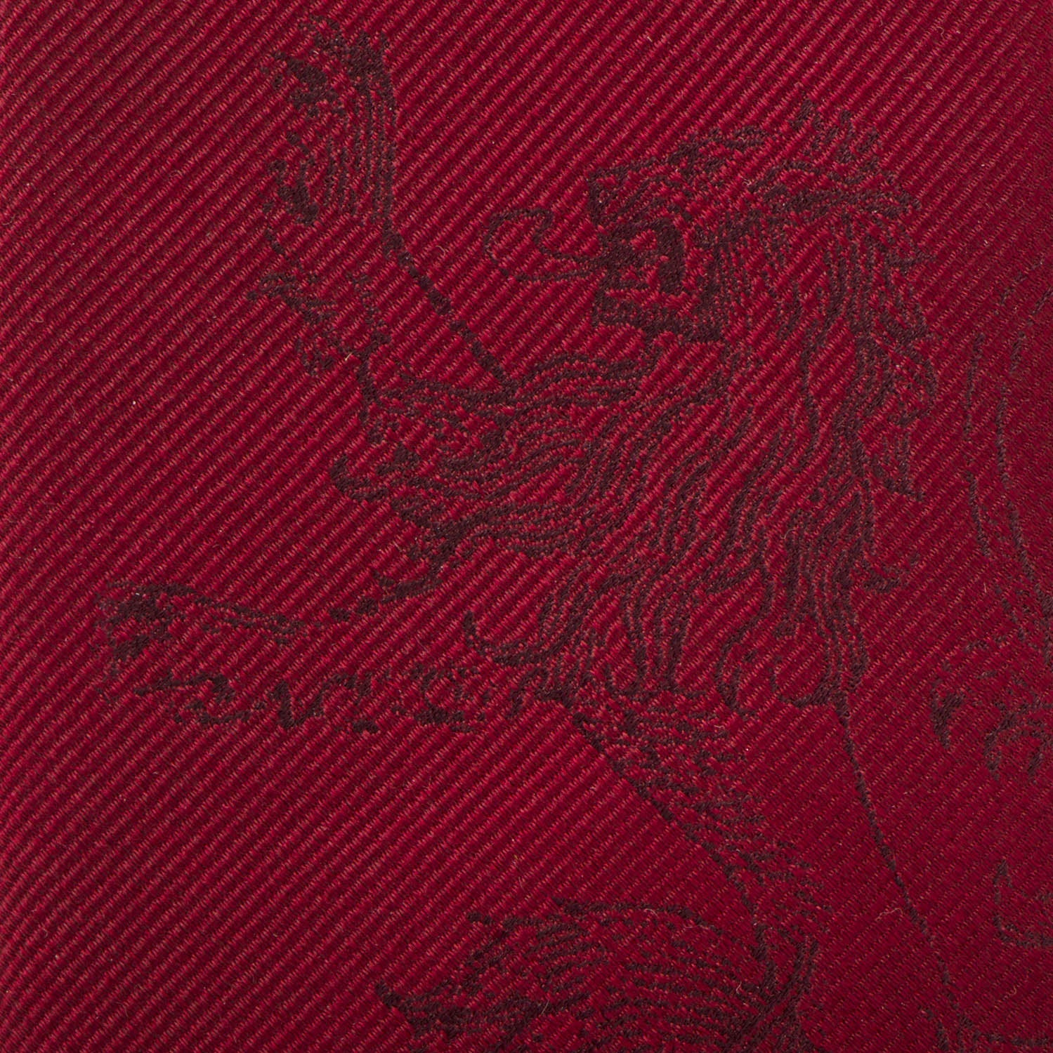 Close-up of a red fabric with a black embroidered design on a red background