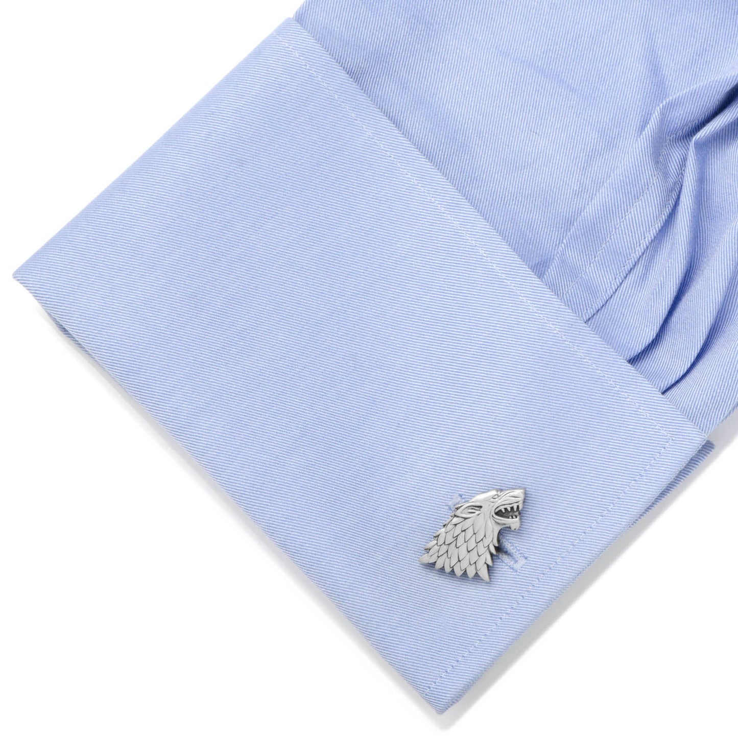 Cufflink on a light blue shirt cuff