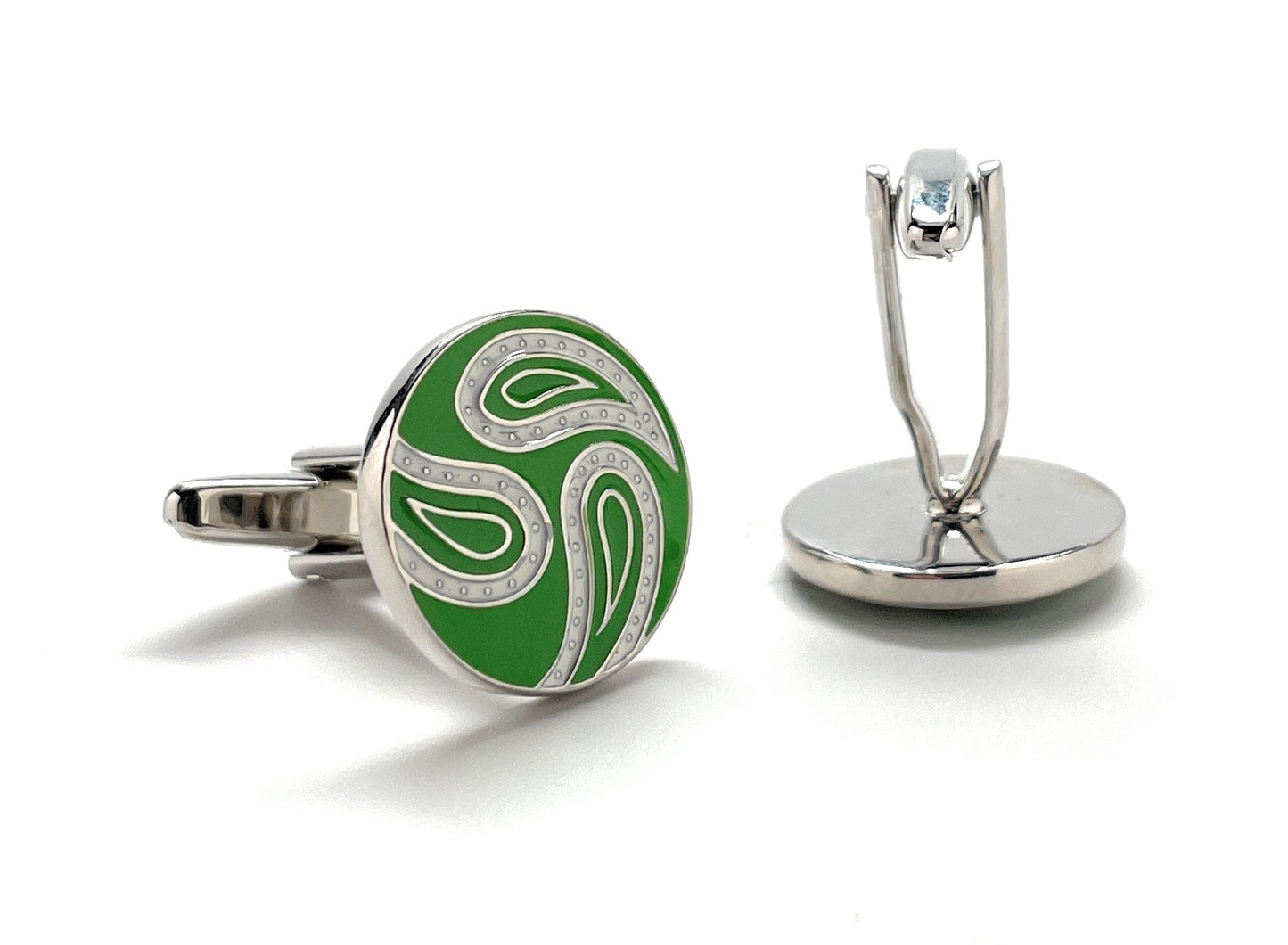 Green and silver cufflinks on a white background