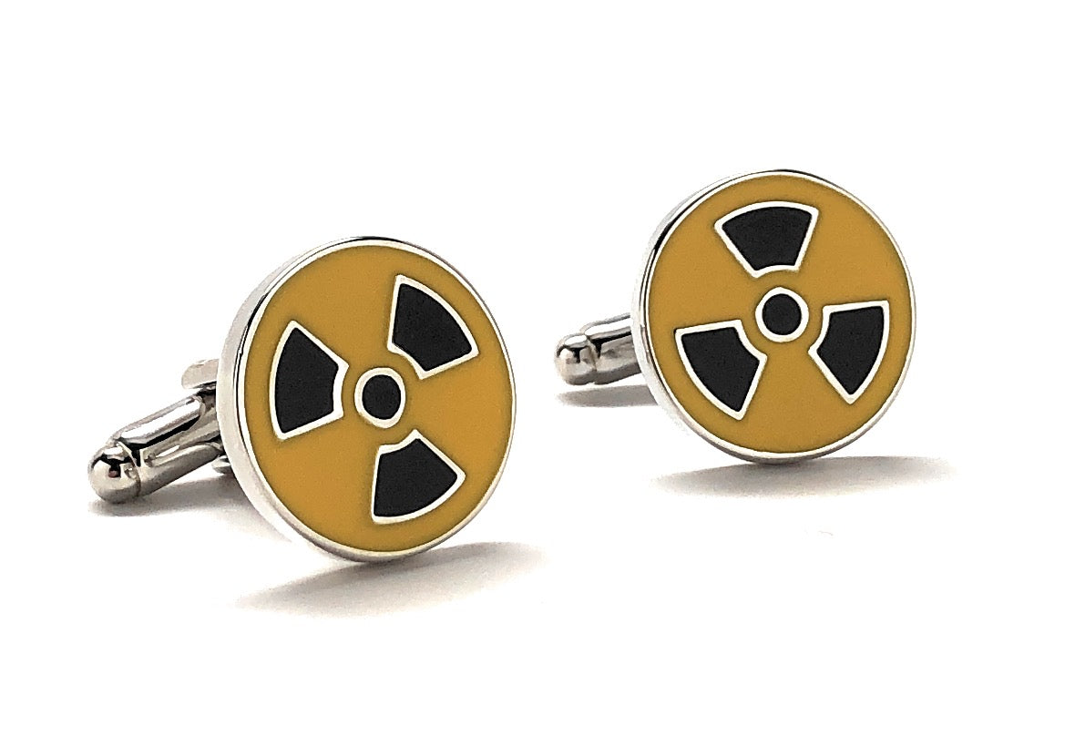 A pair of yellow and black enamel cufflinks with a radioactive symbol design.