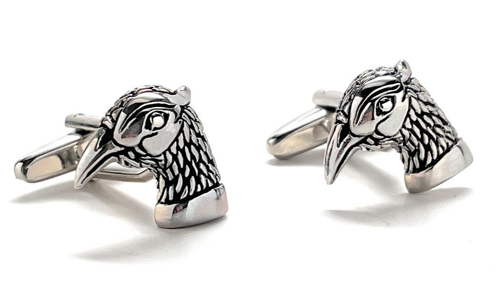 Silver bird-shaped cufflinks on a white background