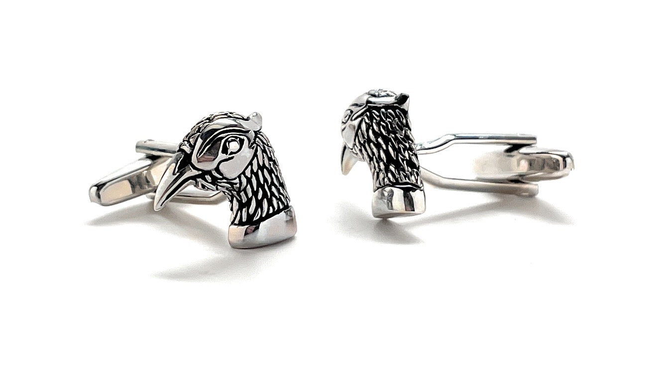 Silver horse head cufflinks on a white background