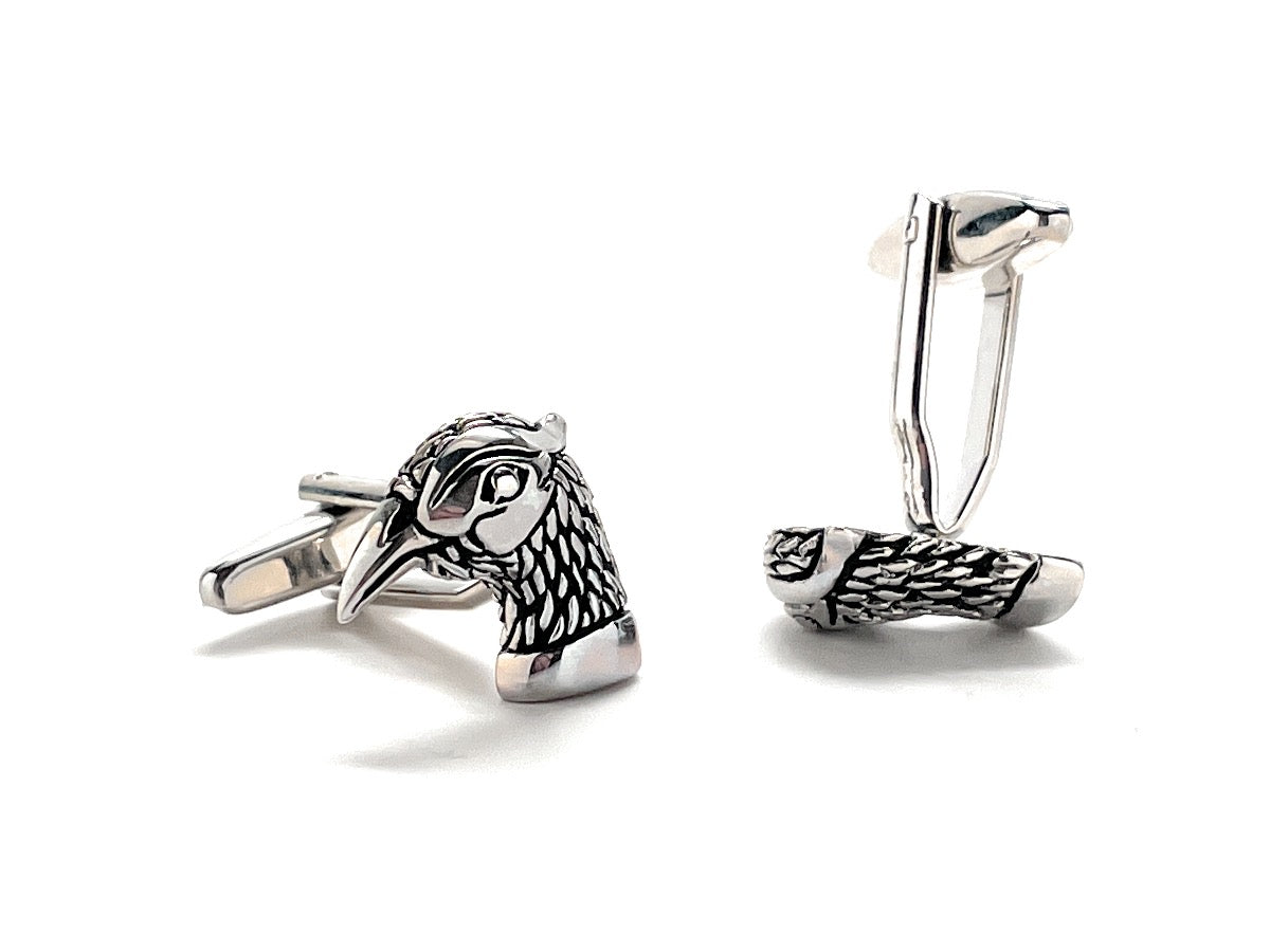Silver bird-shaped cufflinks on a white background