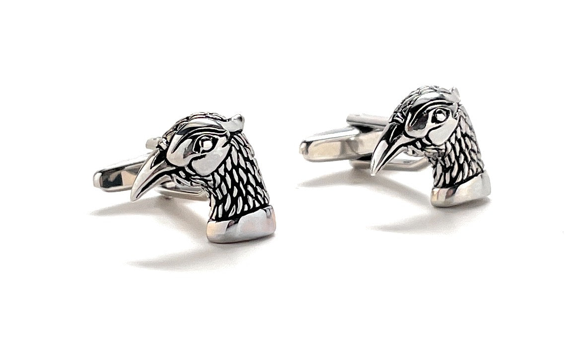 Pair of silver bird-shaped cufflinks on a white background
