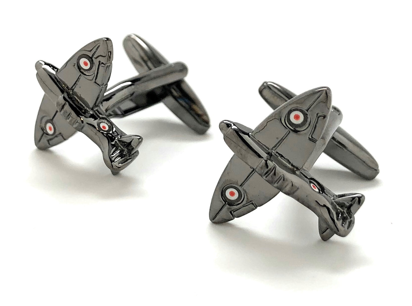 Metallic airplane-shaped cufflinks on a white background