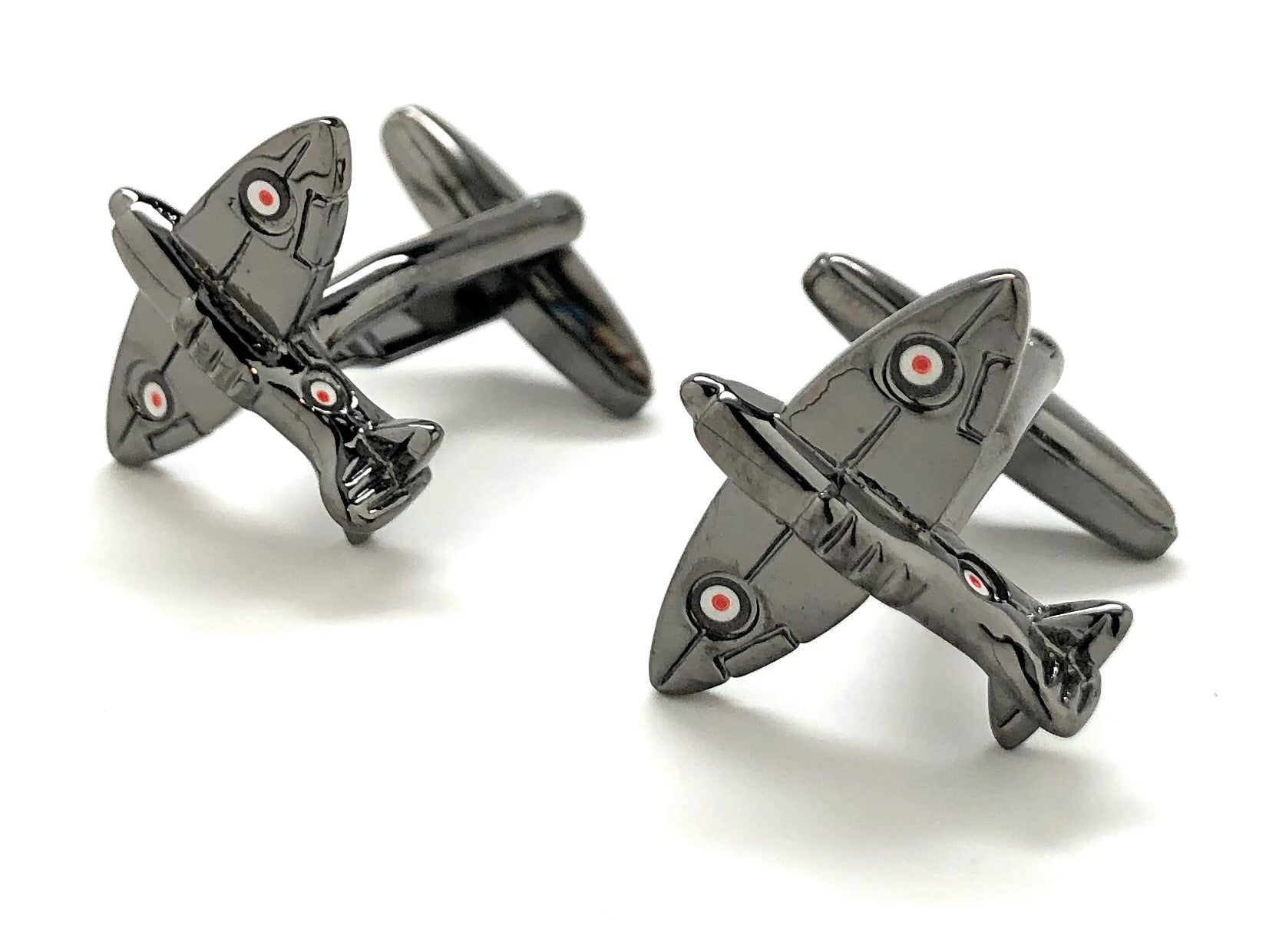 Metallic airplane-shaped cufflinks on a white background