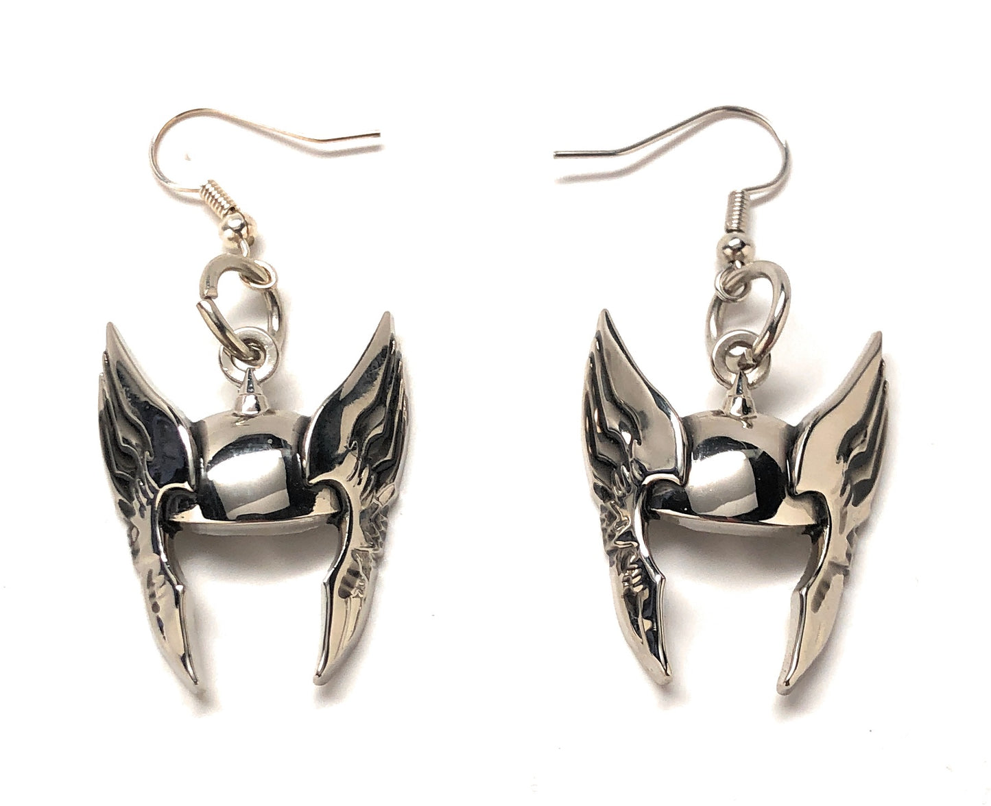 Pair of silver wing-shaped earrings on a white background