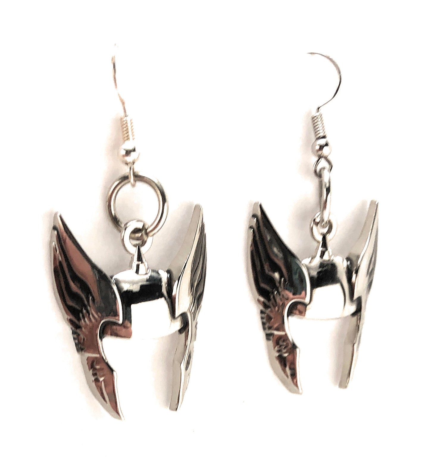 Pair of silver wing-shaped earrings on a white background