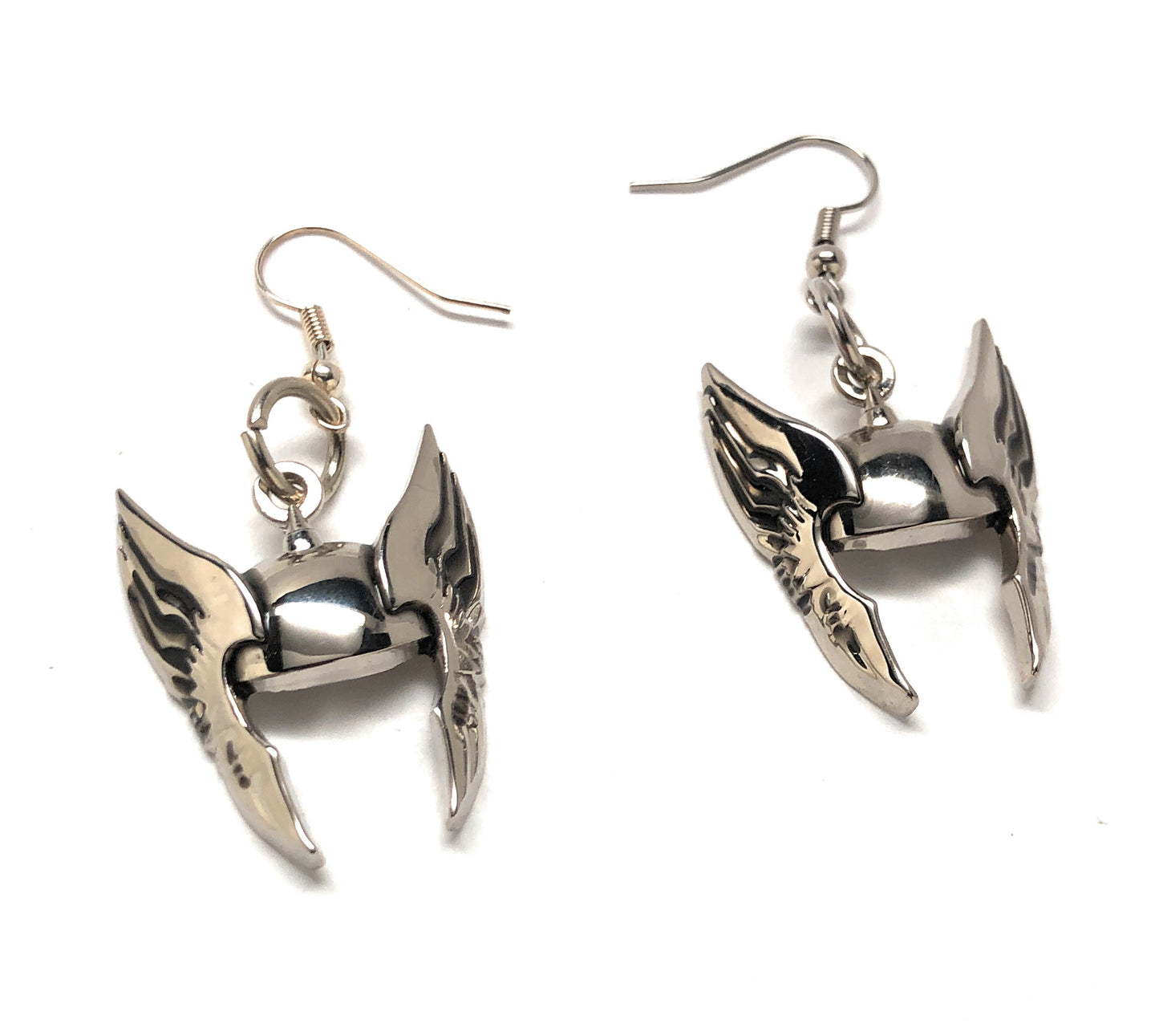 Pair of silver winged earrings on a white background