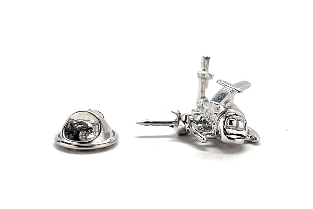 Silver airplane-shaped lapel pin on a white background