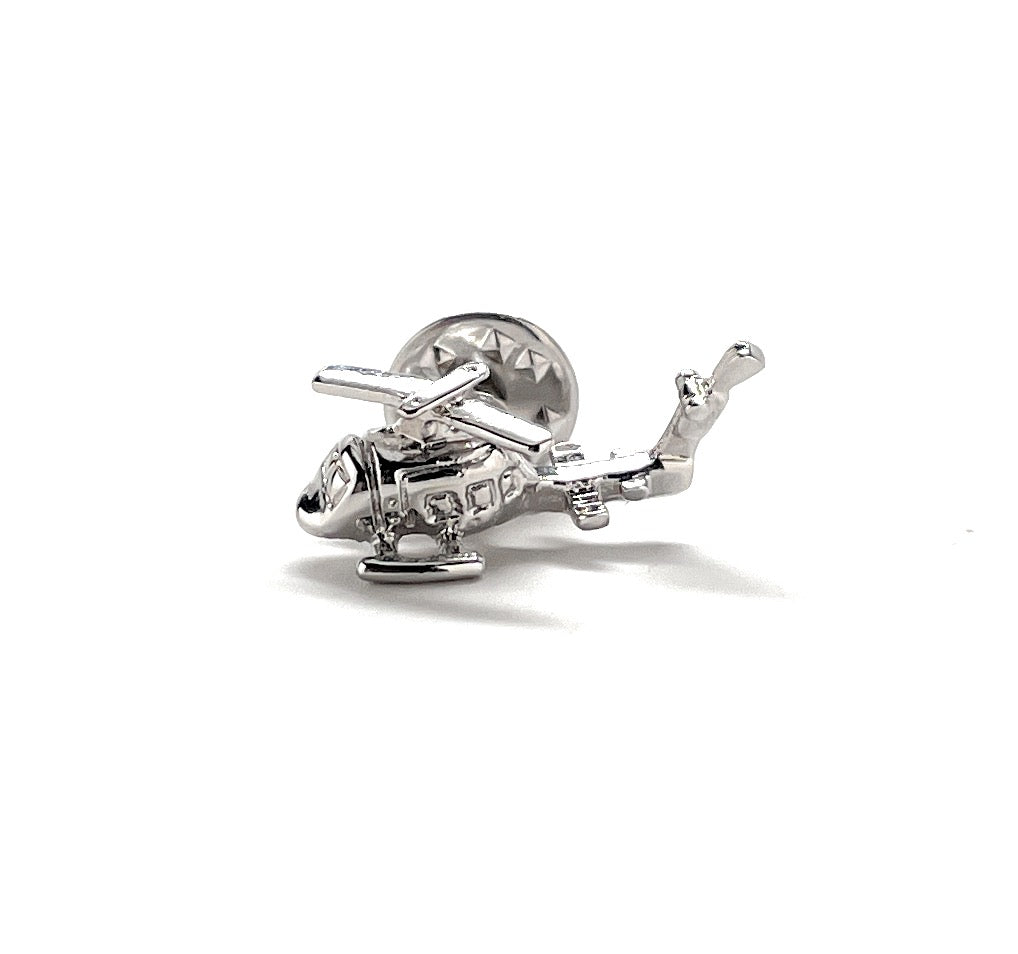 Silver helicopter charm on a white background