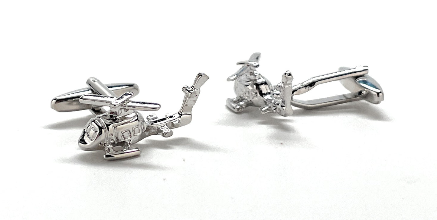 Silver helicopter-shaped cufflinks on a white background