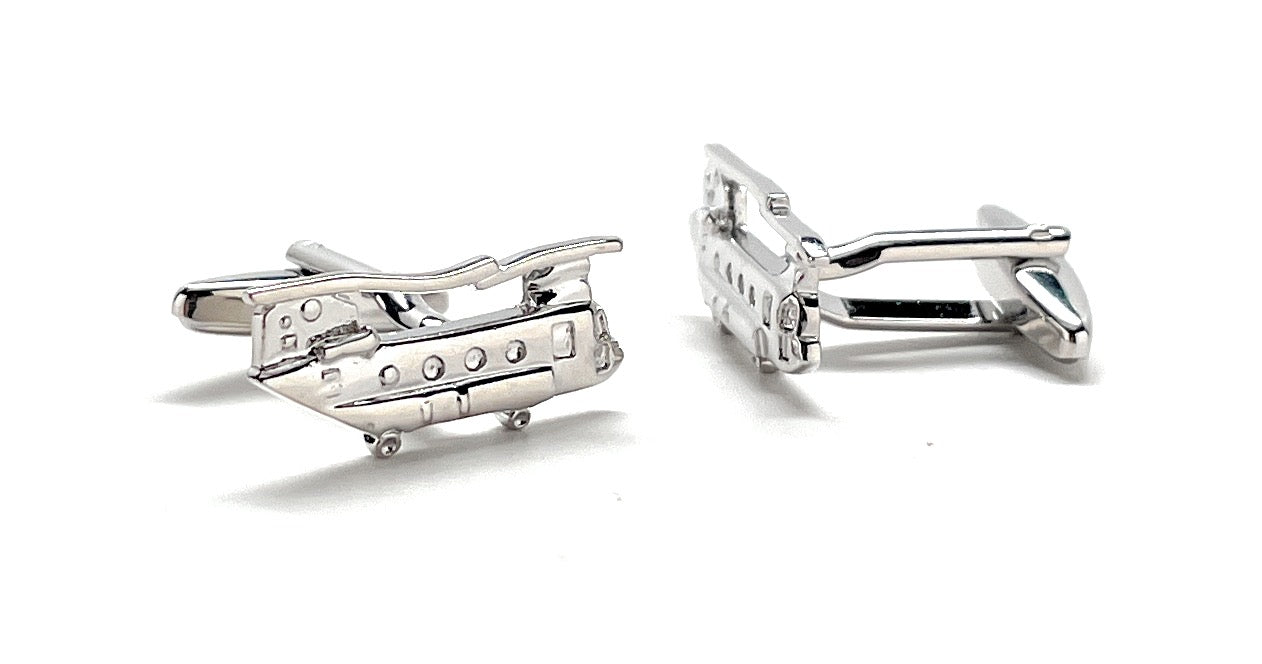 Silver airplane-shaped cufflinks on a white background