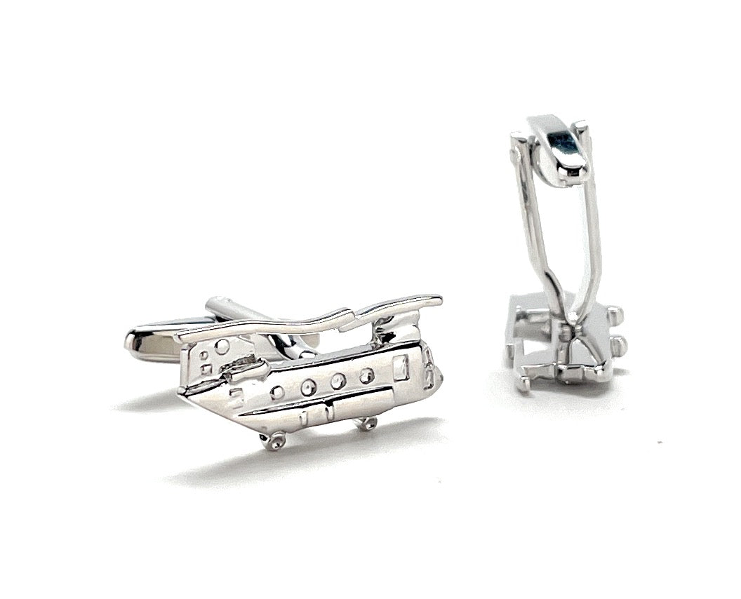 Silver airplane-shaped earrings on a white background