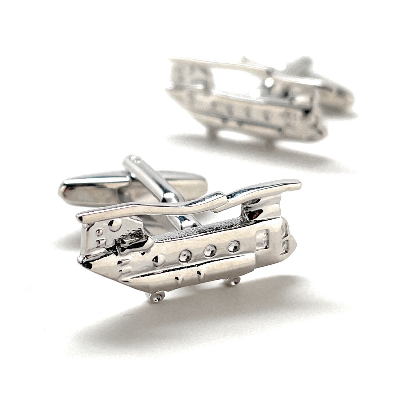 Silver airplane cufflinks on a white background