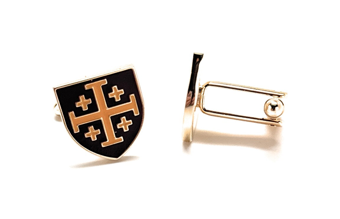 Cufflinks with a black shield design featuring gold crosses on a white background