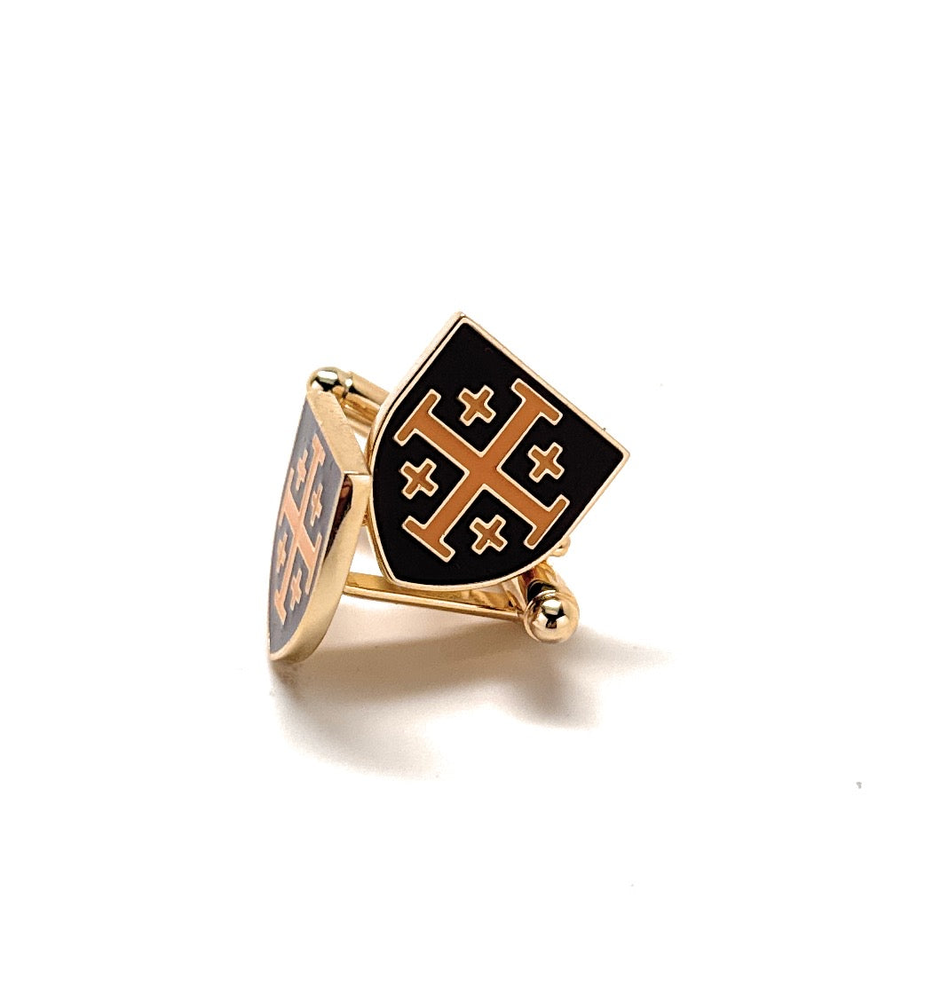 Gold and black shield-shaped cufflinks on a white background