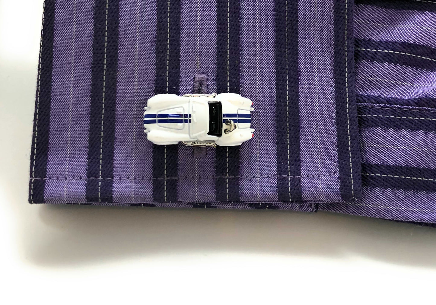 Cufflink on a purple striped shirt