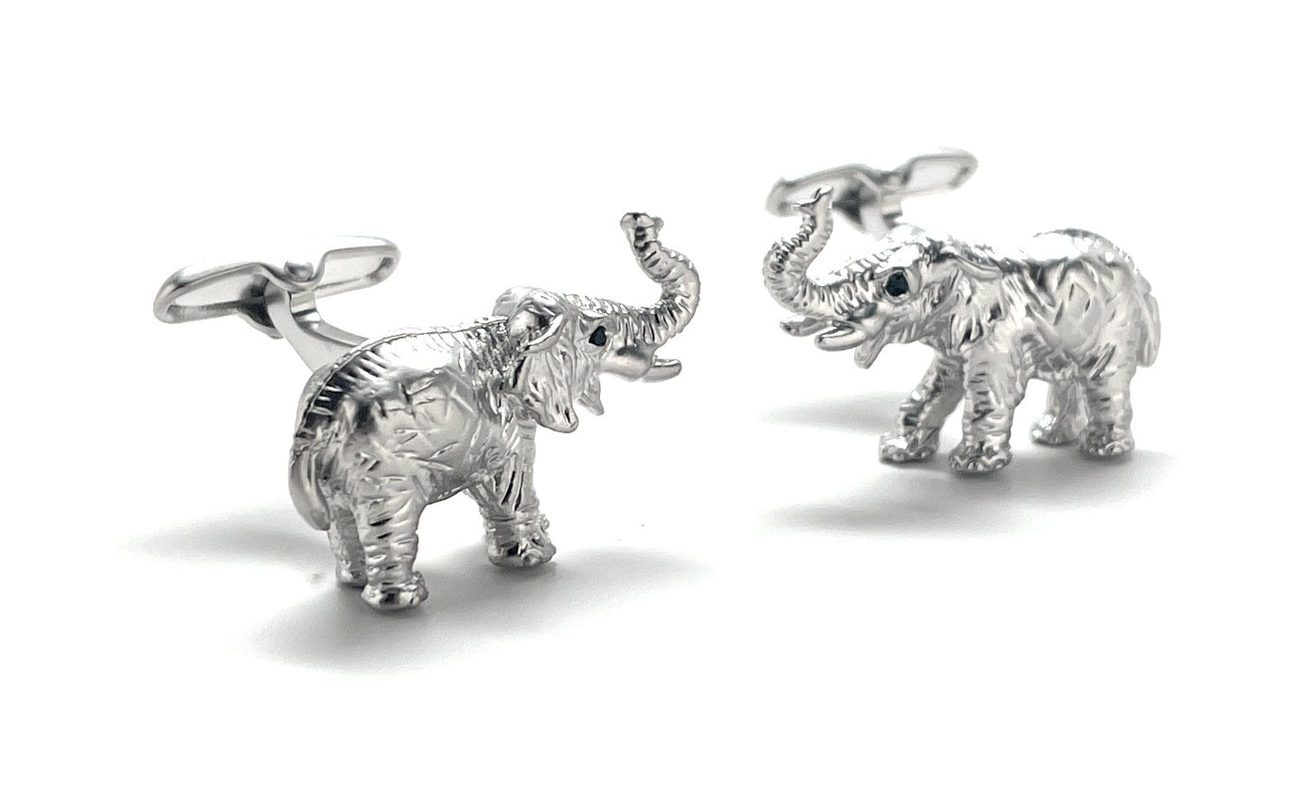 Silver elephant cufflinks on a white background
