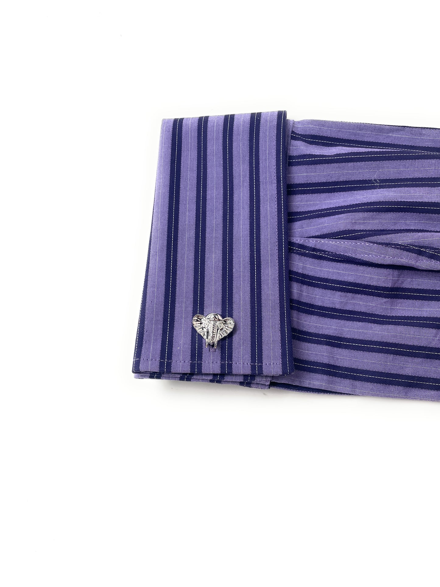 Purple striped fabric with a heart-shaped brooch on a white background