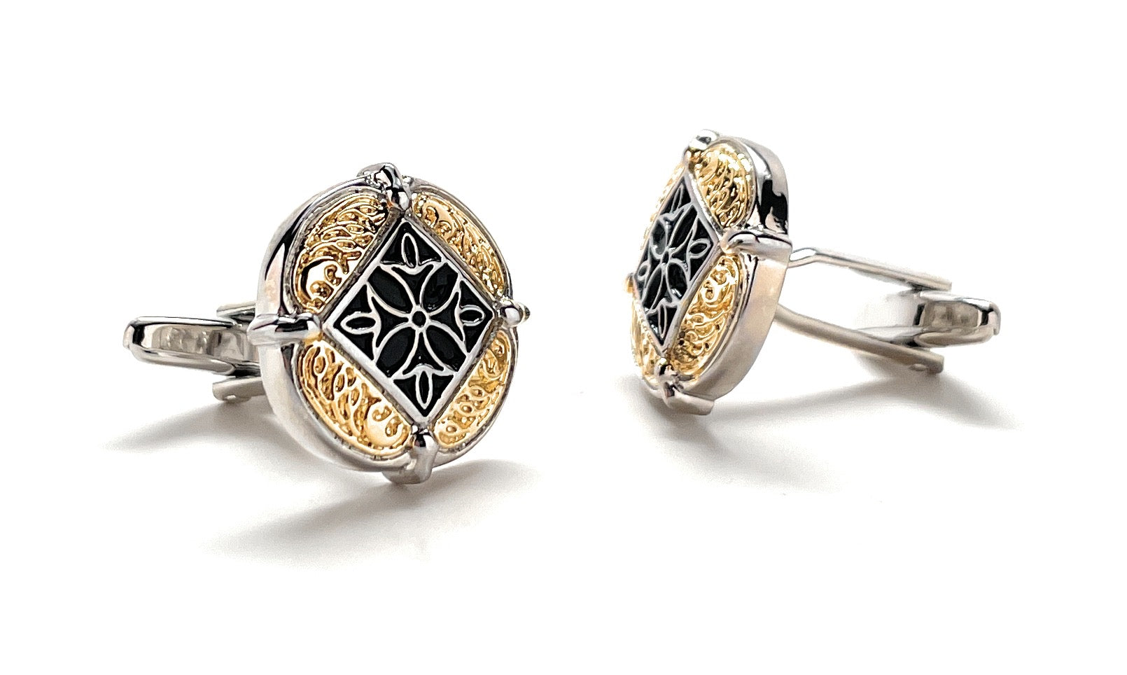 Pair of cufflinks with intricate design on a white background