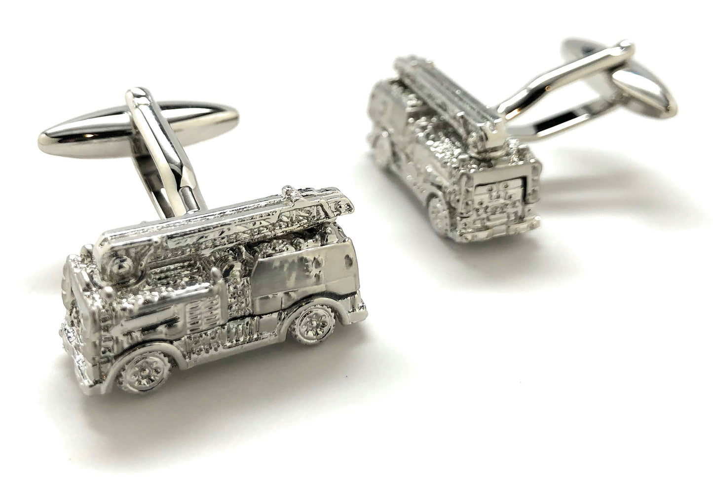 Silver fire truck cufflinks on a white background