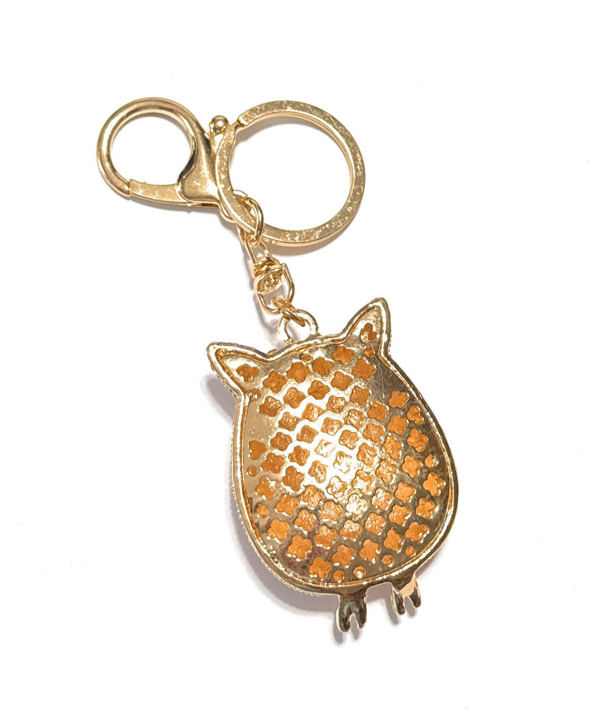 Gold owl-shaped keychain on a white background