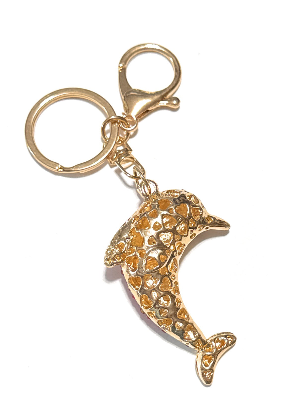Gold dolphin-shaped keychain on a white background