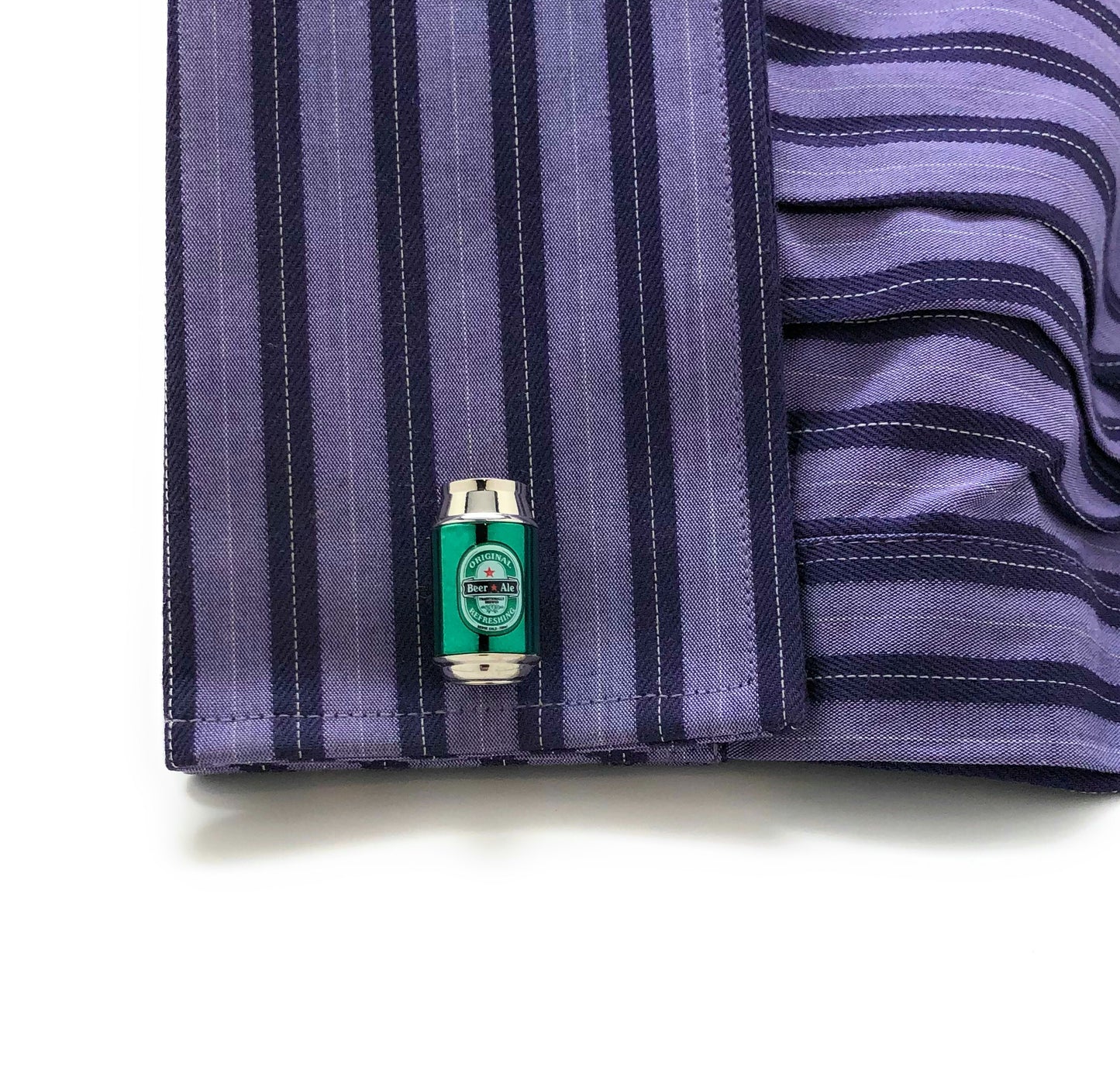 Close-up of a striped shirt with a cufflink on a white background