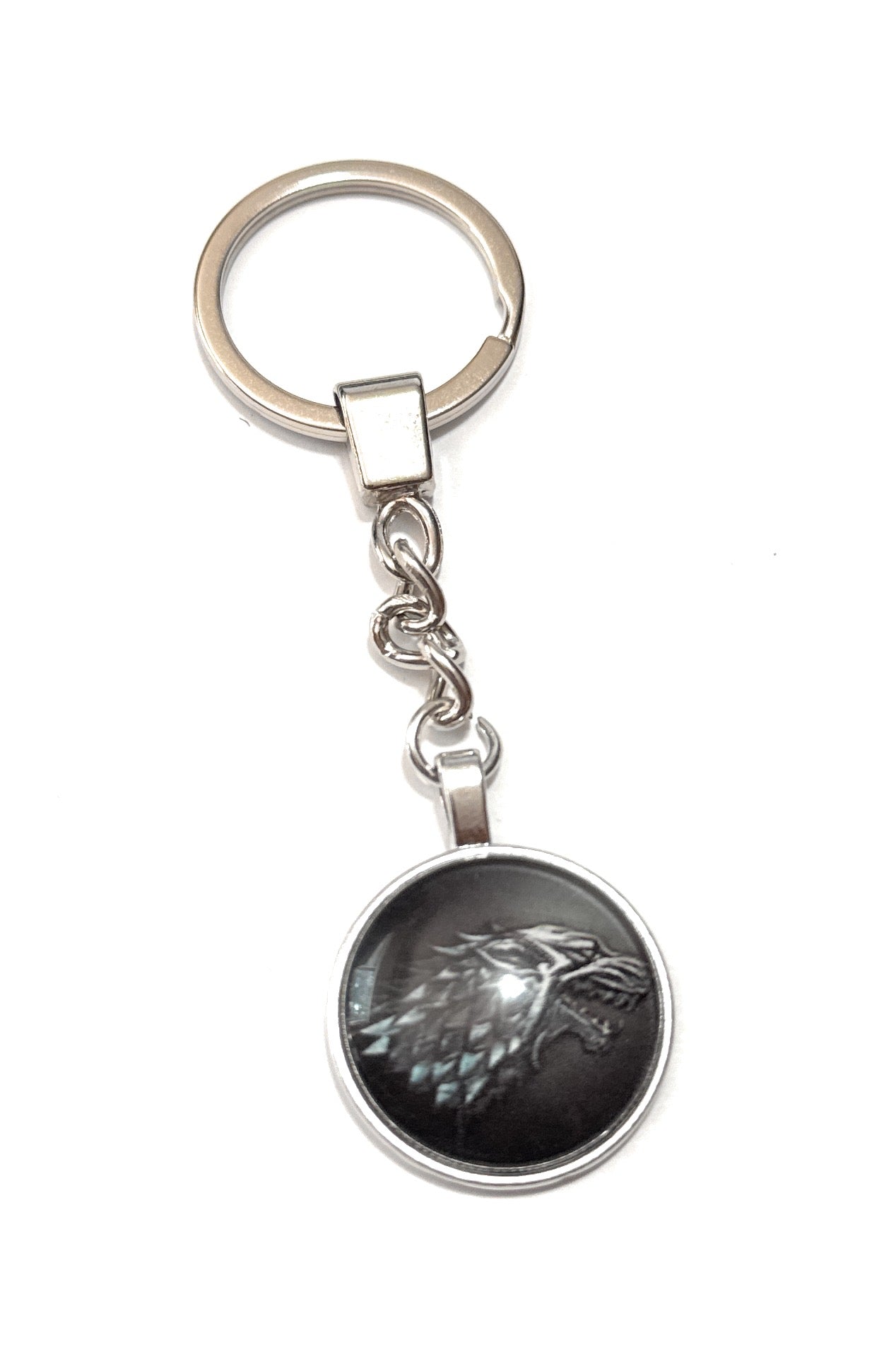 Keychain with a black and silver emblem on a white background
