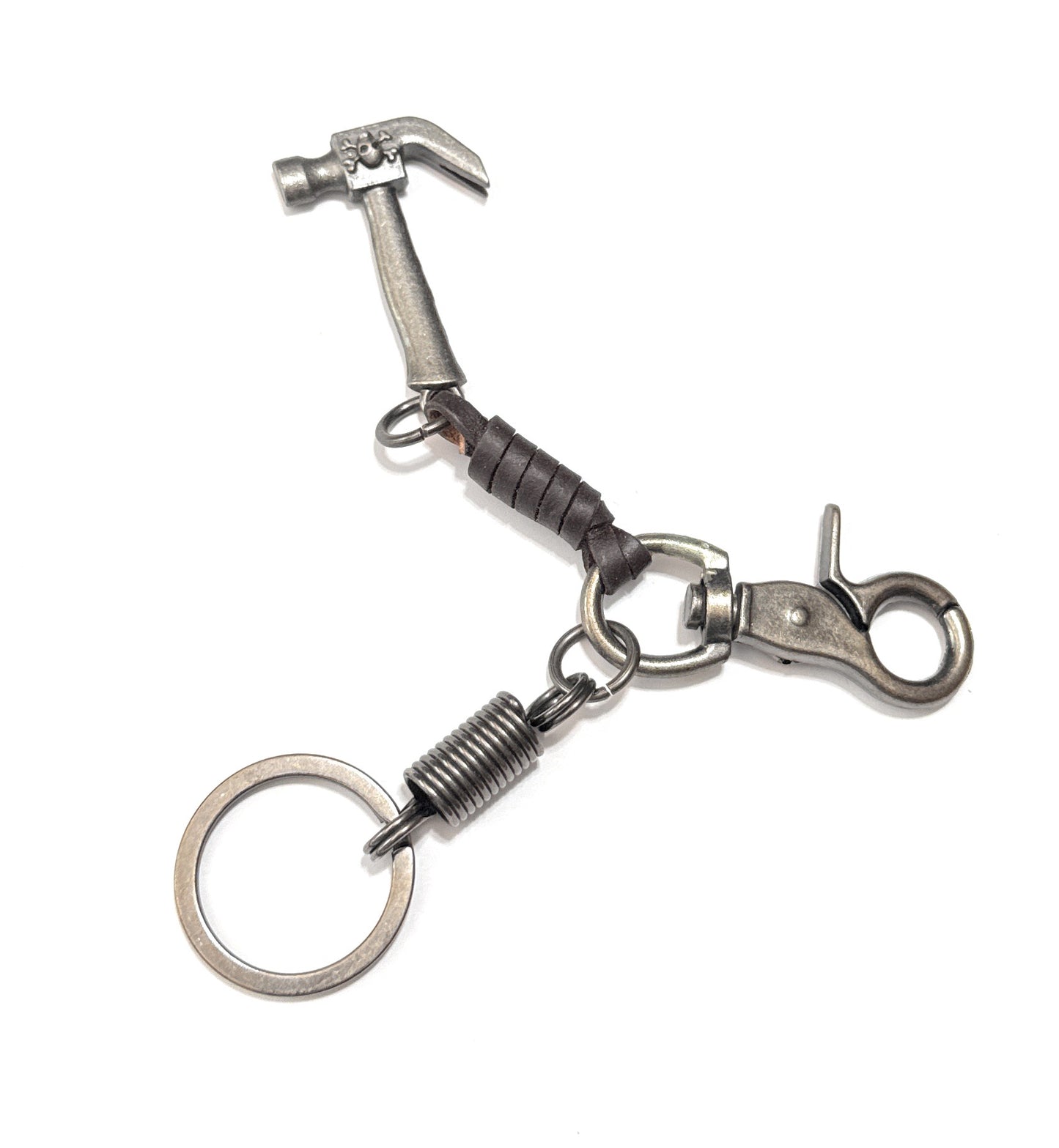 Metal keychain with hammer and spring design on a white background
