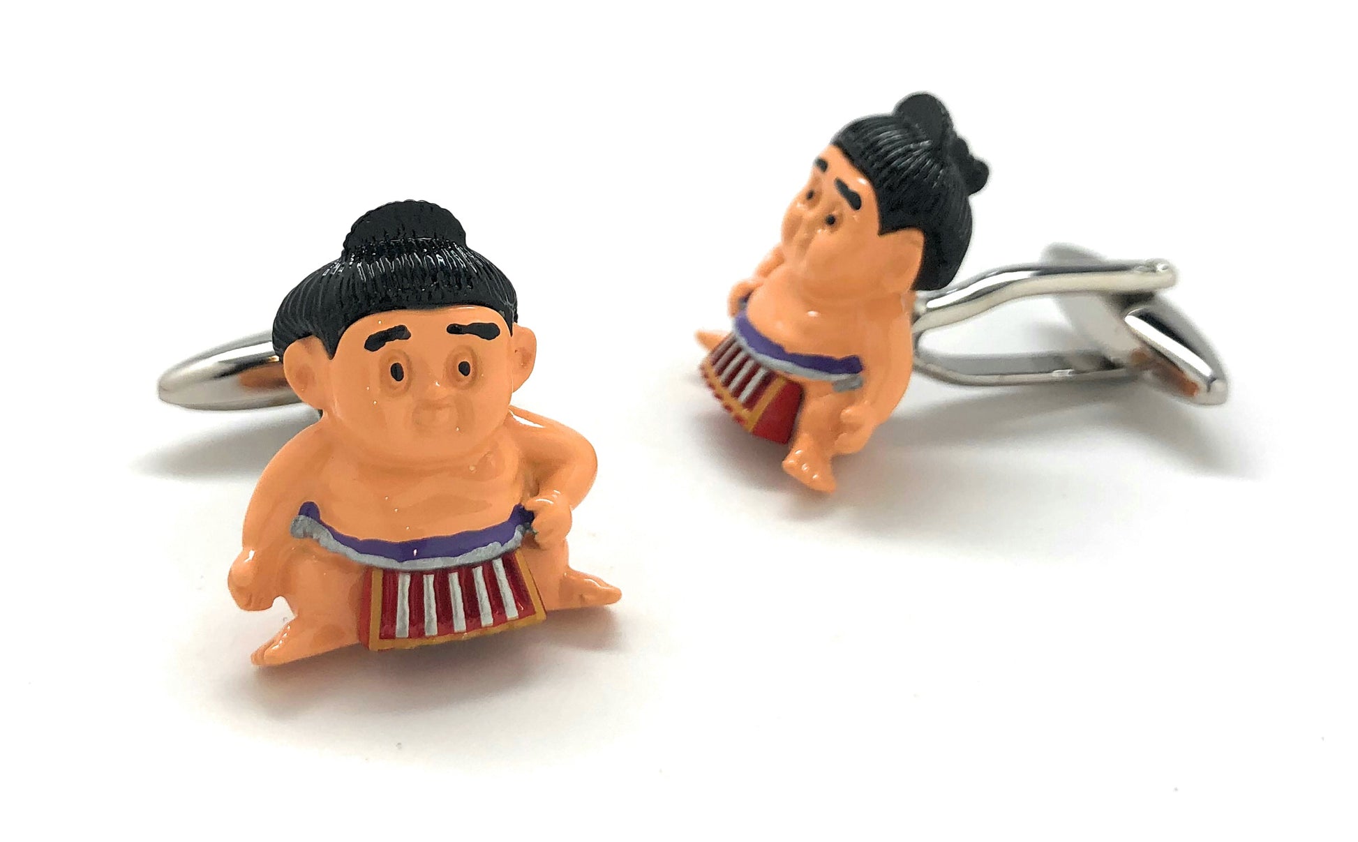 Two sumo wrestler keychains on a white background