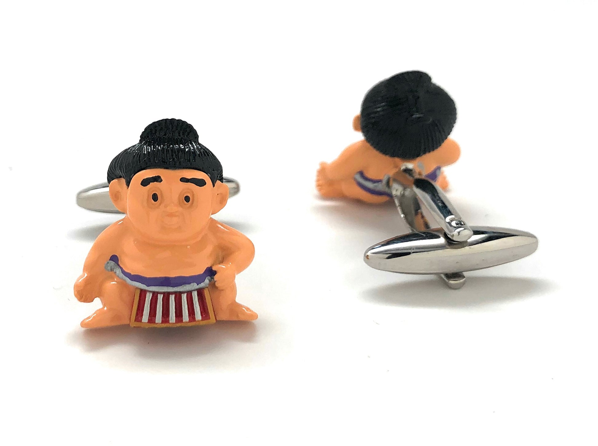 Sumo wrestler cufflinks on a white background