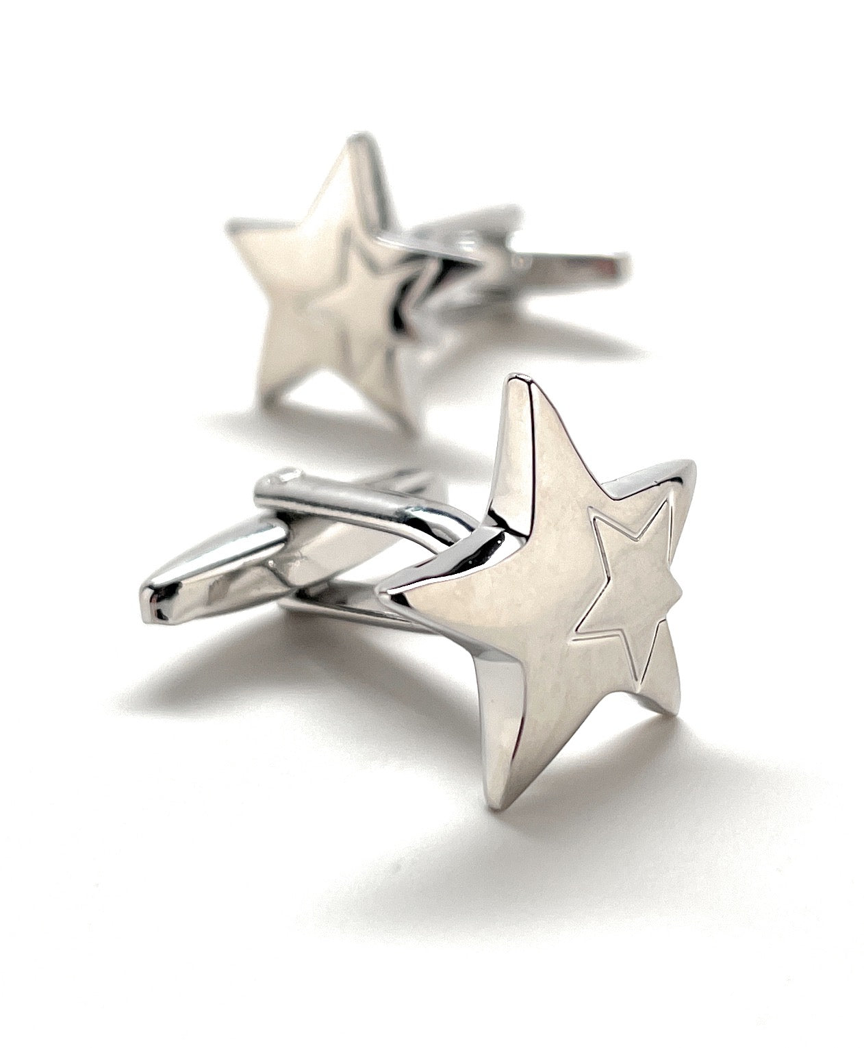 Star-shaped silver cufflinks on a white background