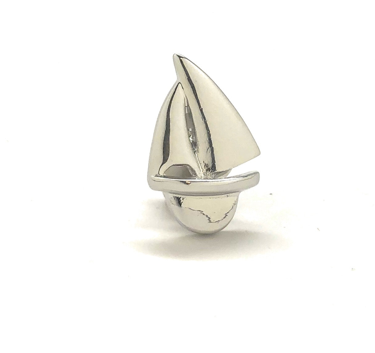 Silver sailboat ornament on a white background