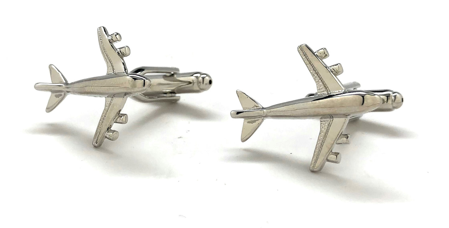 Silver airplane cufflinks on a white background