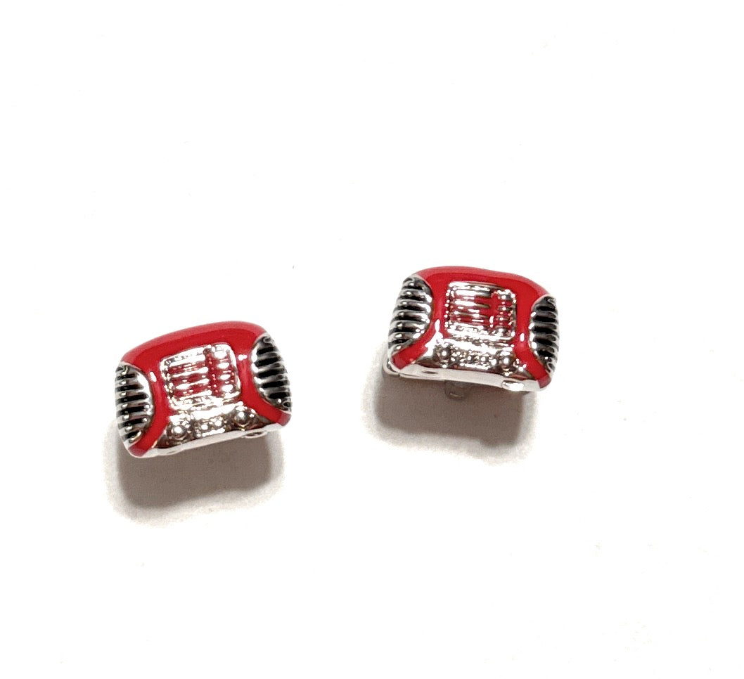 Red and silver rectangular charm on a white background