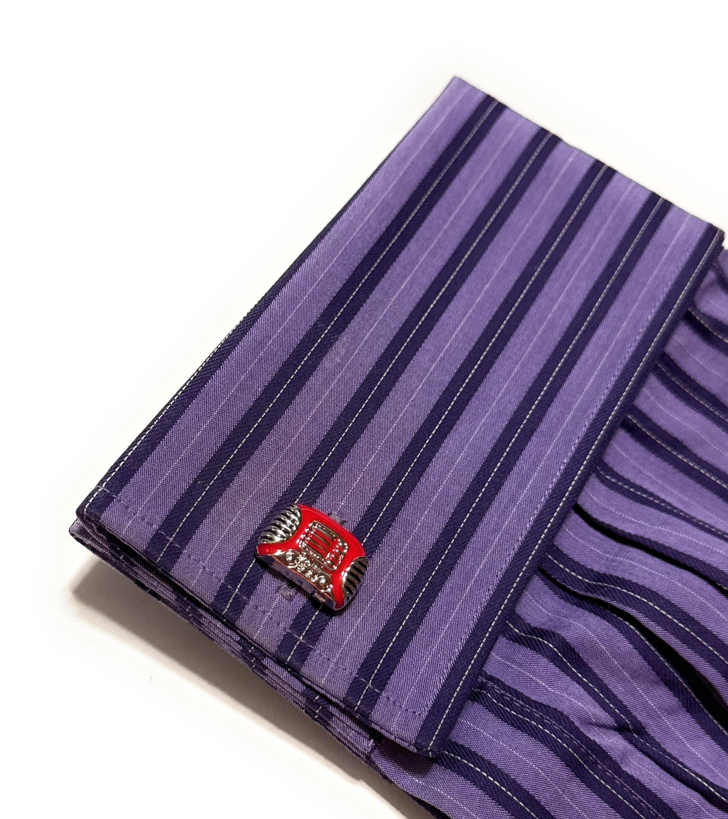 Purple striped fabric with a red and silver emblem on a white background