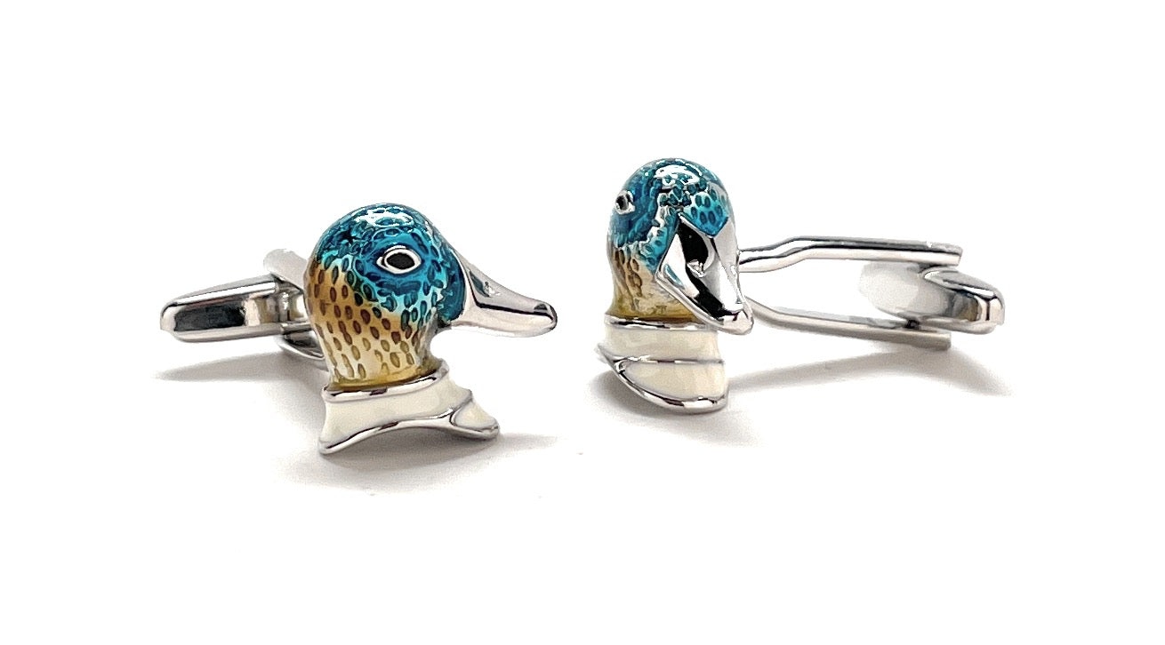 Cufflinks designed like whale tails with blue and gold accents on a white background