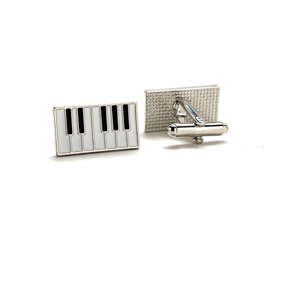 Two cufflinks with piano key design on a white background