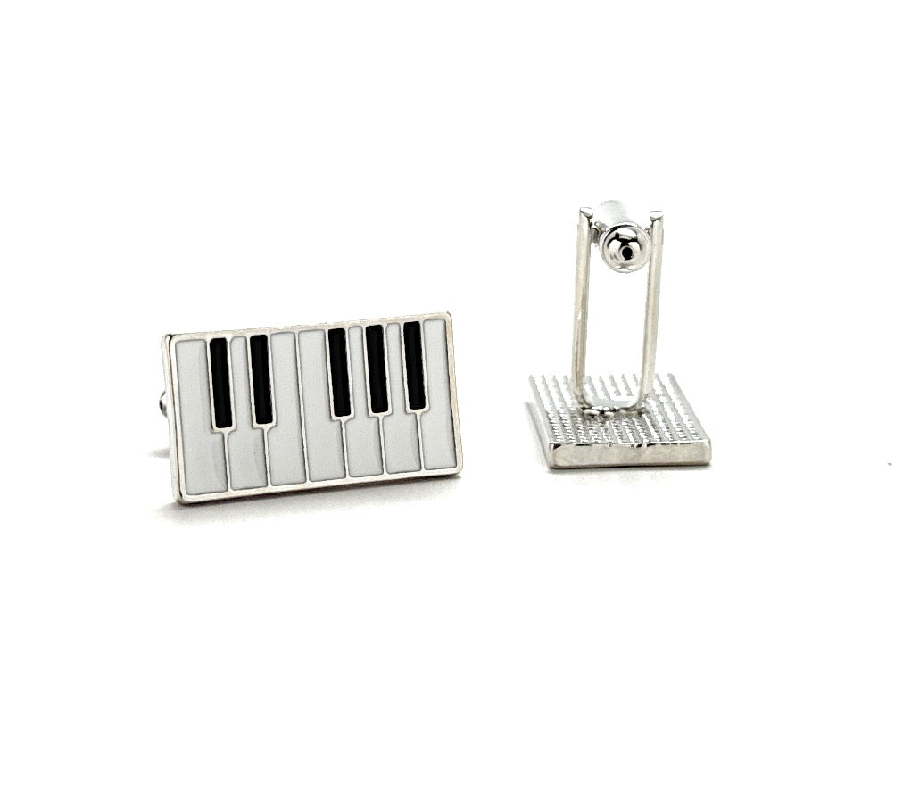 Piano key-shaped cufflinks on a white background