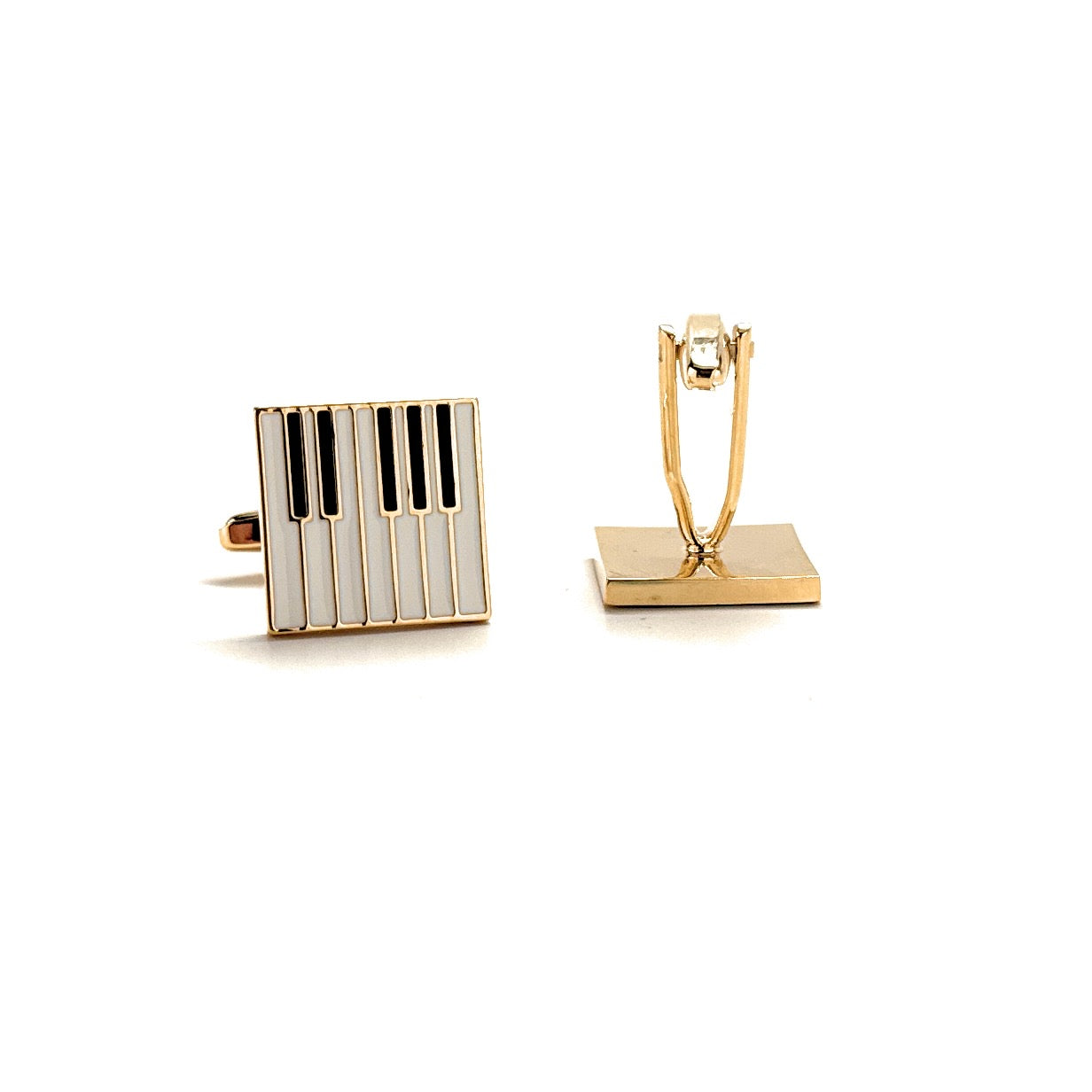 Gold and black piano key-shaped cufflinks on a white background