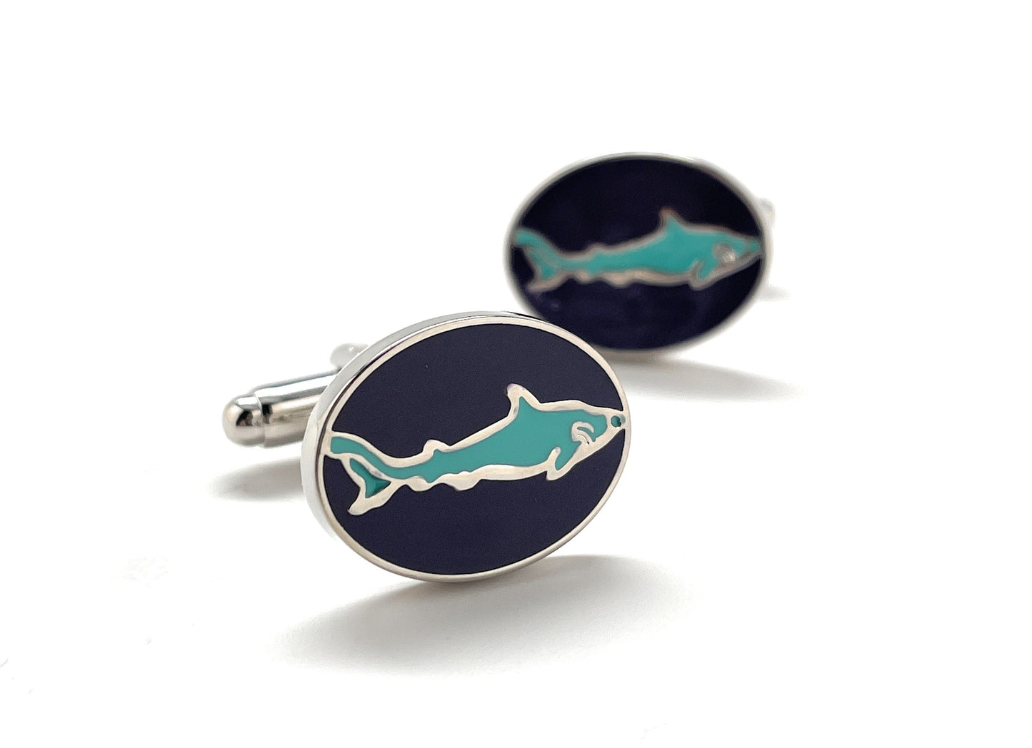 Cufflinks with shark design on a white background