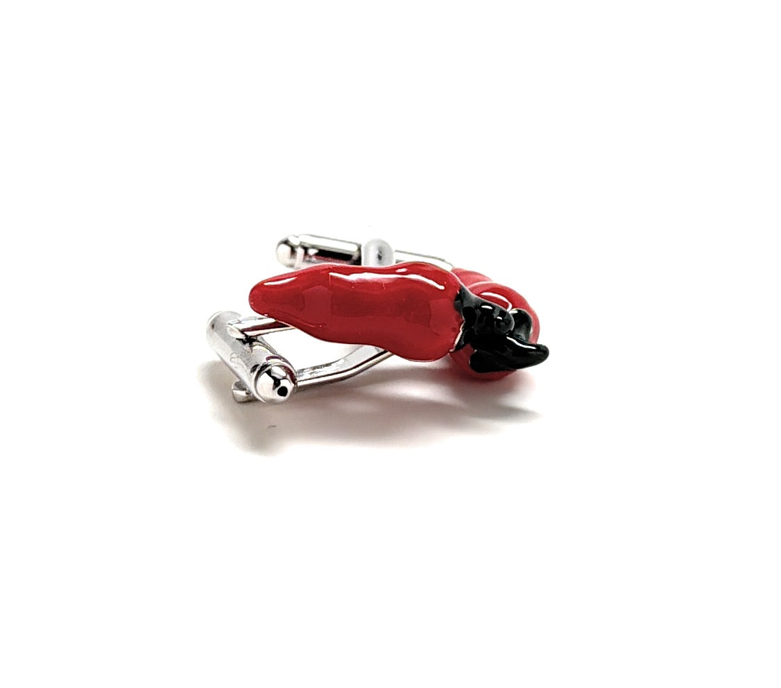 A pair of vibrant red enamel pepper cufflinks with silver hardware by JayPins, representing bold, spicy fashion with playful style.